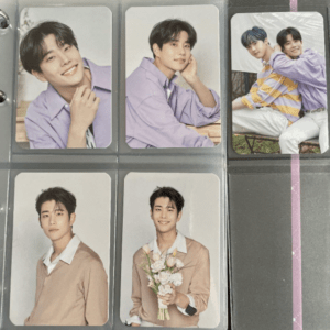 Six portrait photo cards of a young man with dark hair, wearing a lavender shirt, arranged in plastic sleeves