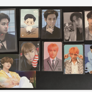Collection of glossy male pop idol photo cards arranged on a black surface.