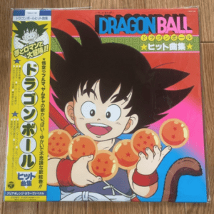 Dragon Ball album cover: a smiling young Goku holds seven glowing orange dragon balls, with a bright red-to-blue gradient background and the bold 'DRAGON BALL' title at the top.