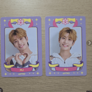 Two purple portrait cards side by side featuring a smiling young man with orange hair; each card says MJ ASTRO.