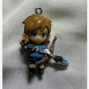 Chibi Link keychain figure with blue tunic and orange hair, holding a bow and sword on a silver background  Articulos Japan (Post Box Japan)