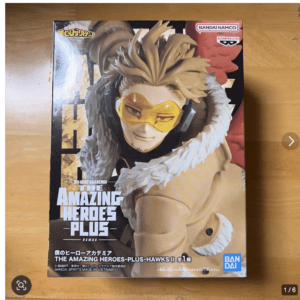 Boxed Hawks action figure from My Hero Academia, The Amazing Heroes-Plus Hawks, on a wooden surface with Bandai logo  Articulos Japan (Post Box Japan)