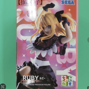 Boxed figure of Ruby from Oshi no Ko, pink background, SEGA logo visible, anime girl with blonde hair in frilly outfit.