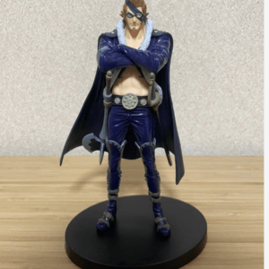 Action figure of a muscular superhero with a blue suit, cape, mask, and crossed arms, standing on a round black display base on a wooden table.
