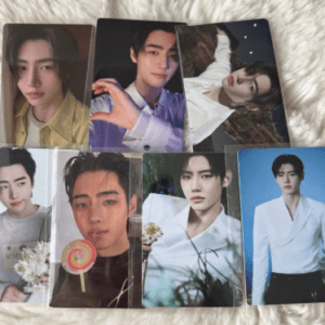 Set of eight glossy photo cards featuring a young man in various outfits, laid out on a soft, light-colored surface. Images show close-ups and full-body poses with different backgrounds and outfits.