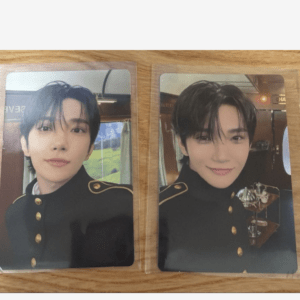 Two glossy photocard prints featuring a young man with black hair wearing a black military-style jacket with gold buttons, shown from the chest up.