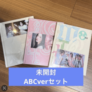 Unopened ABCver set albums laid on a wooden floor with pastel pink, white, and blue covers; Japanese text 未開封 on a blue banner below.