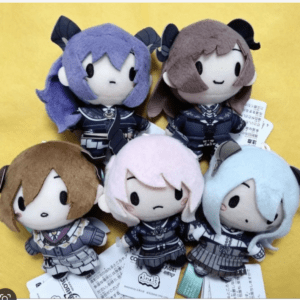 Six chibi plush figures with pastel hair colors (purple, brown, pink, light blue) in navy uniforms, arranged on a bright yellow background, posing together as a group.