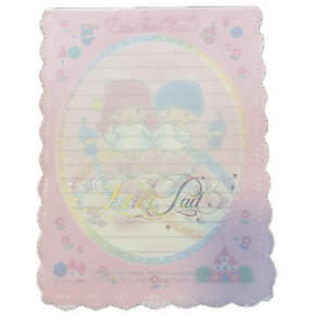 Pastel pink notebook or pad with Little Twin Stars characters, scalloped edges, and holographic script on the cover.