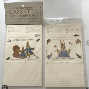 Two vintage Little Grey Rabbit cassette index cards with orange-brown text and rabbit illustrations, laid side by side on a white surface.