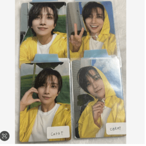 Set of four photo cards showing a young man with wet dark hair in a bright yellow raincoat, posing in different shots; two cards show him making a peace sign. Two cards have a 'CARAT' label at the bottom.