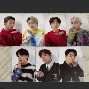 Eight photo cards arranged in two rows of four on a patterned surface, each showing a young man making playful gestures.
