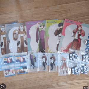 Colorful set of anime character posters and collectible cards spread on a wooden floor, featuring characters in bright outfits and various accessories.