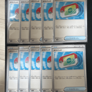 Multiple Japanese Pokémon cards in sleeves laid out on a surface, all showing a 'Pokepad' card image with a red and white device on a blue background (trainer card).