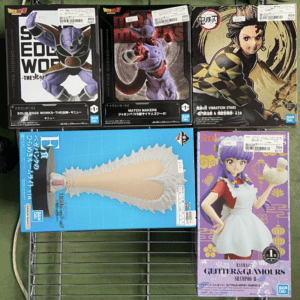 Boxed anime figures on a store rack: three Dragon Ball Z figures on top and two smaller figures below.  Articulos Japan (Post Box Japan)