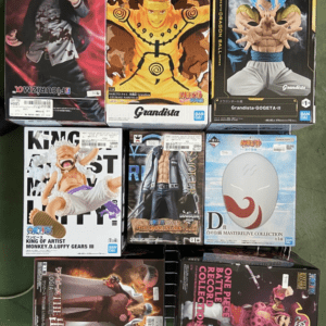 Assorted boxed anime figures arranged on a display rack, featuring characters from Naruto, Dragon Ball, and One Piece titles.