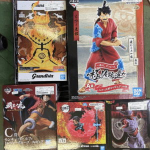 Boxed anime action figures on a wire rack, including Luffy from One Piece and Naruto characters as the central items.