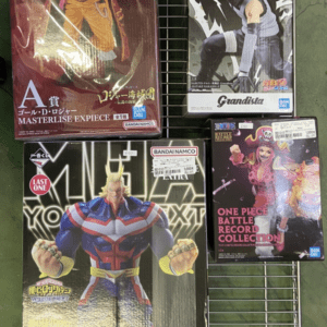 Boxed anime figures on a wire rack, including Masterlise Expiece Luffy on the left and Grandista Naruto on the top right, displayed in plastic wrap.