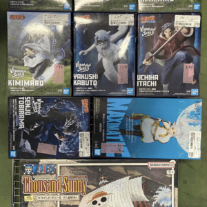 Rows of boxed anime figures on a display rack, including Naruto characters Kimimaro, Kabuto, Itachi, and a One Piece Thousand Sunny ship model box on the bottom shelf.