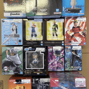 Row of boxed anime action figures arranged on a floor display, featuring characters from popular series like Dragon Ball, One Piece, and Bleach.