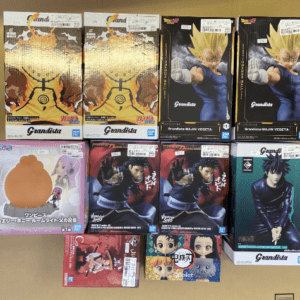 Collection of boxed Grandista Dragon Ball figures arranged on a floor, including Goku (Super Saiyan) and Vegeta boxes visible.