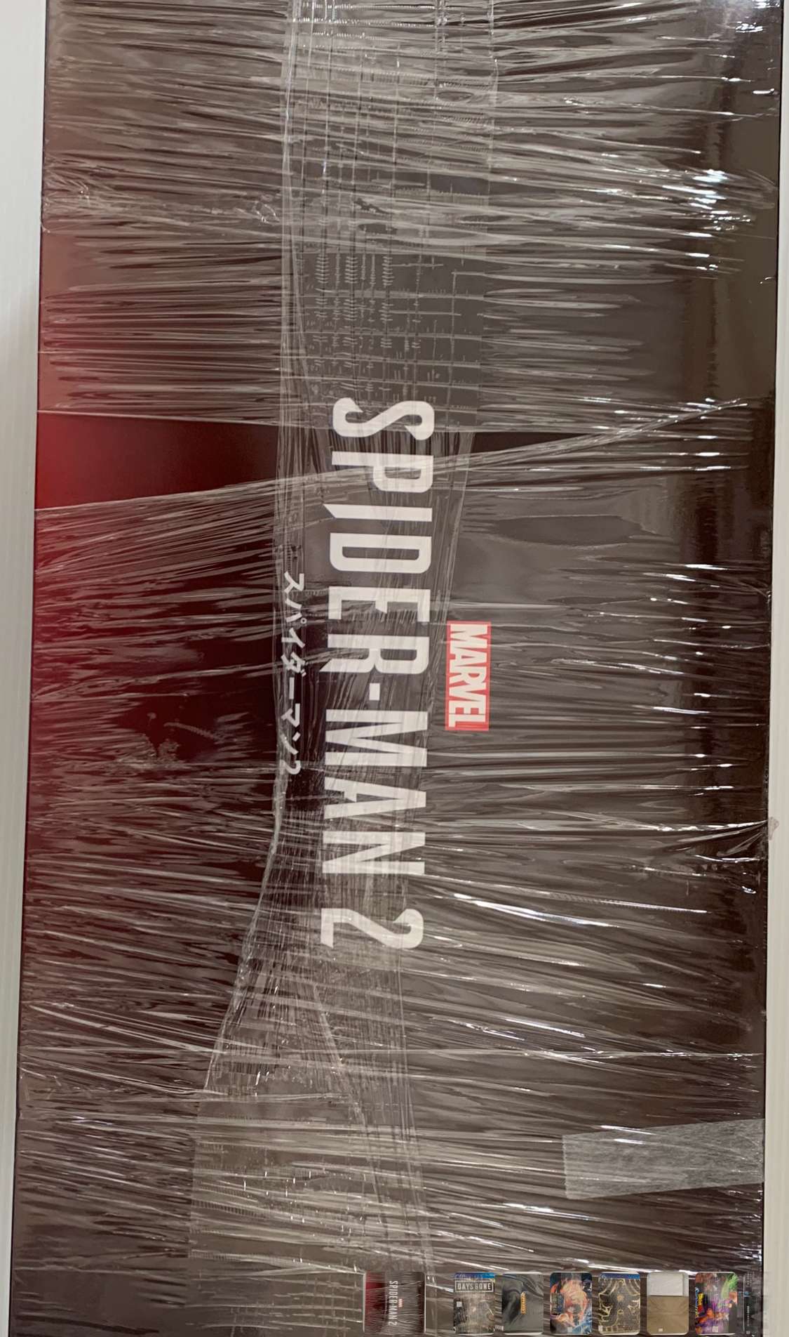 Img_2560 - Articulos Japan (post Box Japan) Vertical view of a Marvel Spider-Man 2 box sealed in clear shrink wrap, standing upright. Articulos Japan (Post Box Japan)