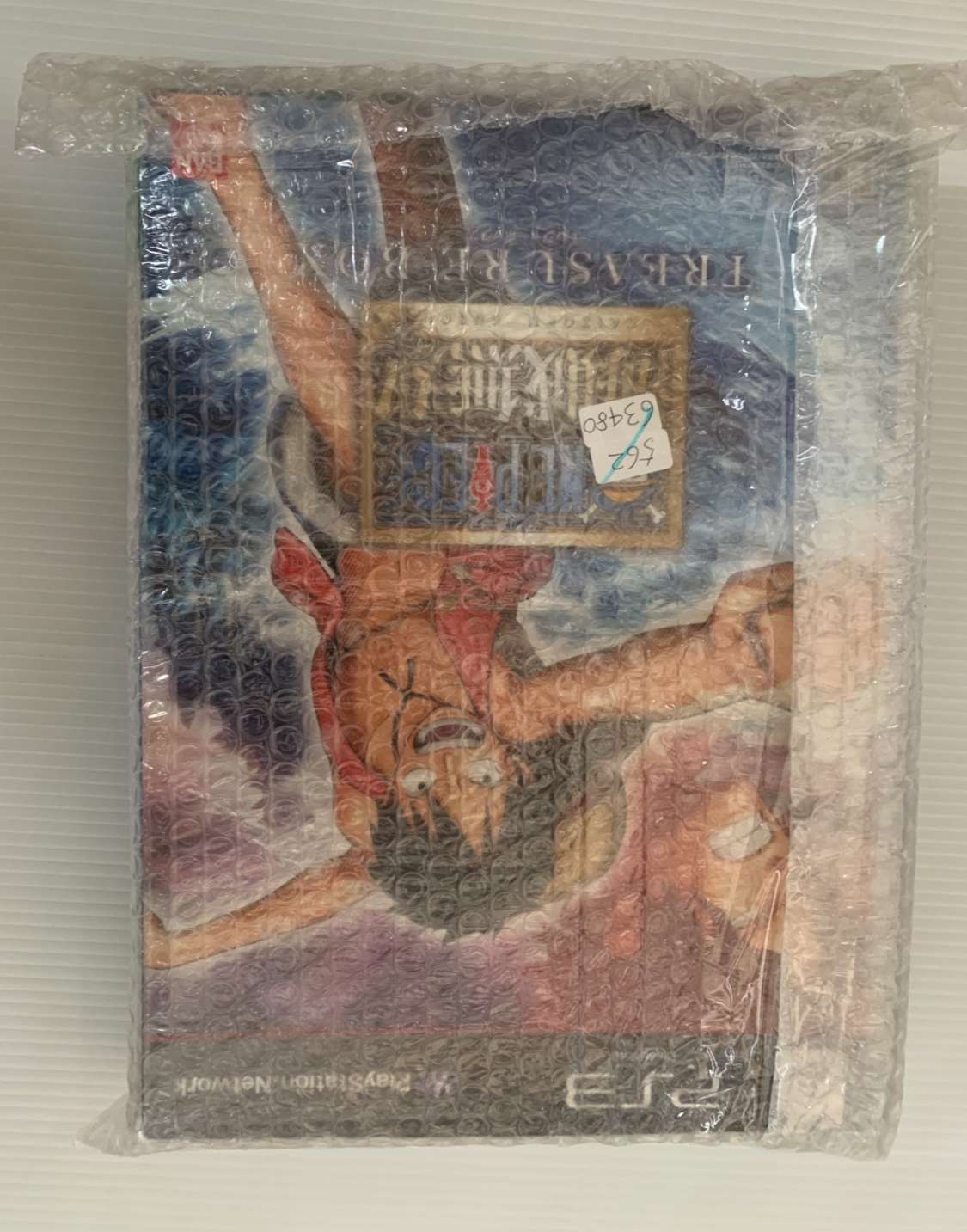 Img_2569 - Articulos Japan (post Box Japan) PlayStation Portable game case wrapped in bubble wrap; part of the colorful cartoon cover shows through the plastic. Articulos Japan (Post Box Japan)