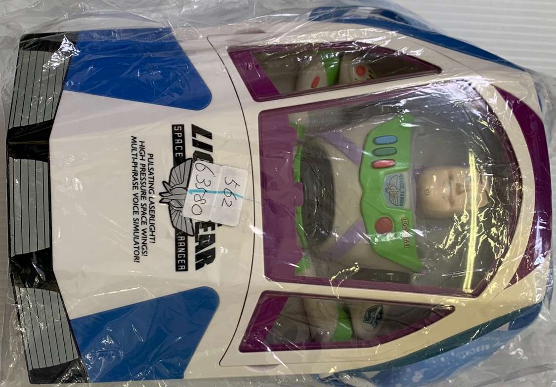 Img_2582 - Articulos Japan (post Box Japan) Colorful toy space shuttle sealed in a plastic bag, cockpit visible with green controls. Articulos Japan (Post Box Japan)