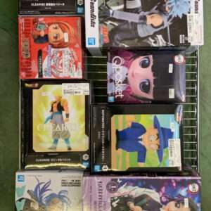 Shelf of boxed anime figures on a metal rack, featuring Dragon Ball, One Piece, and other character boxes.