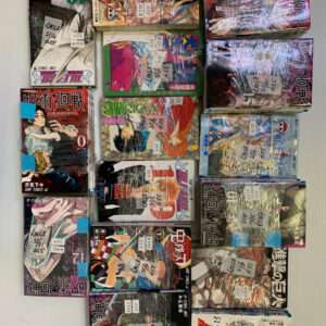 Colorful stack of manga boxes arranged in a wall display, each wrapped with price stickers and handwritten tags.