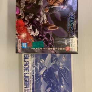 Three boxed model kits laid on a surface; top box features a muscular fighter battling a purple creature with Japanese text on the side.