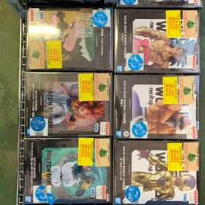 Row of boxed anime figure sets on a metal display rack with yellow sale stickers visible on several boxes.