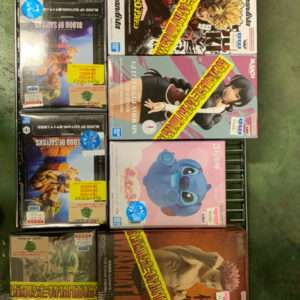 Shelf of boxed anime and video game figurines on a metal display rack, viewed from above in a store.