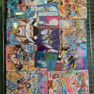 Rows of colorful One Piece manga volumes arranged on a metal rack, covers featuring Luffy and the crew with bold 'ONE PIECE' titles