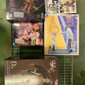Boxed anime action figures on a wire display rack, various sizes and package art visible (Japanese text).