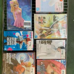 Assorted anime figure boxes arranged on a metal wire rack, seen from above.
