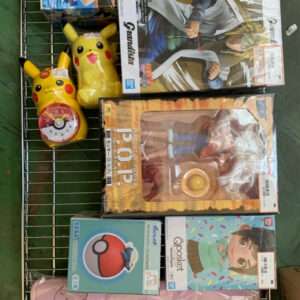 Metal display rack filled with assorted boxed toys and figures, including a yellow Pikachu clock and a pink Pokémon tote bag.