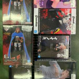 Collection of boxed anime figures arranged on a metal display rack, featuring characters from One Piece and other series with price stickers visible on the boxes.