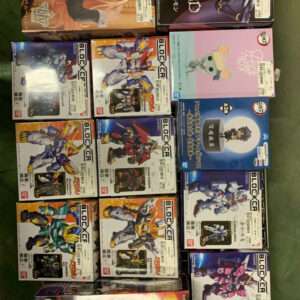 Shelf of boxed anime action figures and model kits in a grid, showing colorful character art on each box.