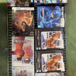 Shelf of boxed anime action figures on a metal rack, colorful box art and Japanese text visible, set on a concrete floor.
