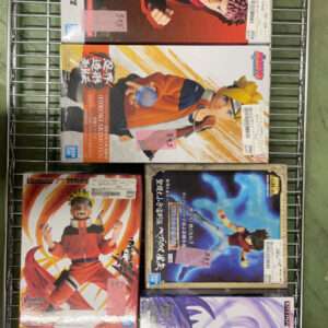 Six boxed anime figurines on a metal display rack in a store (Naruto and other series).
