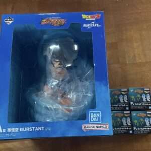 Blue Burstant action-figure box with a window showing the figure inside wrapped in plastic; Bandai Namco logo visible.