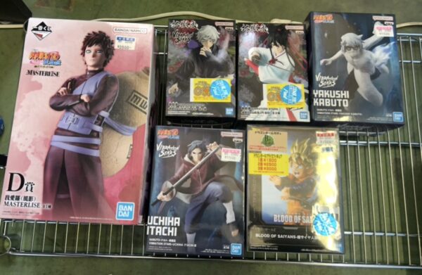 Img_e0689 - Articulos Japan (post Box Japan) Display of Naruto and anime character figurine boxes on a retail wire shelf, including Masterlise figures and Blood of Saiyans boxes Articulos Japan (Post Box Japan)