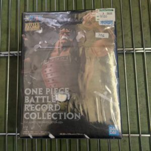 Boxed One Piece Battle Record Collection figure on a metal shelf, Bandai logo visible on the bottom right.