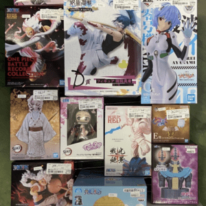 Display rack filled with assorted boxed anime figures in colorful packaging, featuring characters from popular series arranged in tiers on a metal grid.