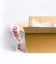Open cardboard box with fragile sticker and bubble wrap on a white surface.  Articulos Japan (Post Box Japan)