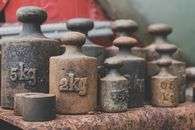 Close-up of various rusted iron weights illustrating antique and vintage appeal.