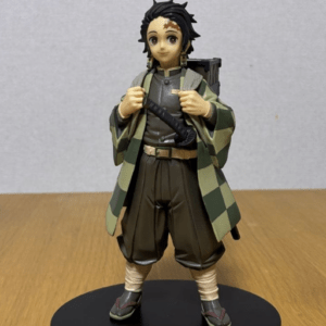 Figure statue resembling Tanjiro Kamado from Demon Slayer, wearing a green checkered haori and holding a sword on a black base.