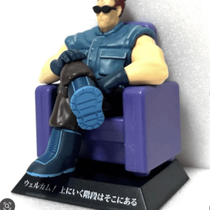 Plastic action figure lounging in a purple armchair, wearing a teal vest, blue boots, gloves, and sunglasses; Japanese caption on the base is visible.