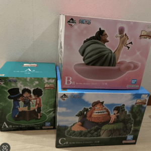 Set of three One Piece Revive Moment figure boxes (A, B, C) stacked on a shelf viewable from the side.